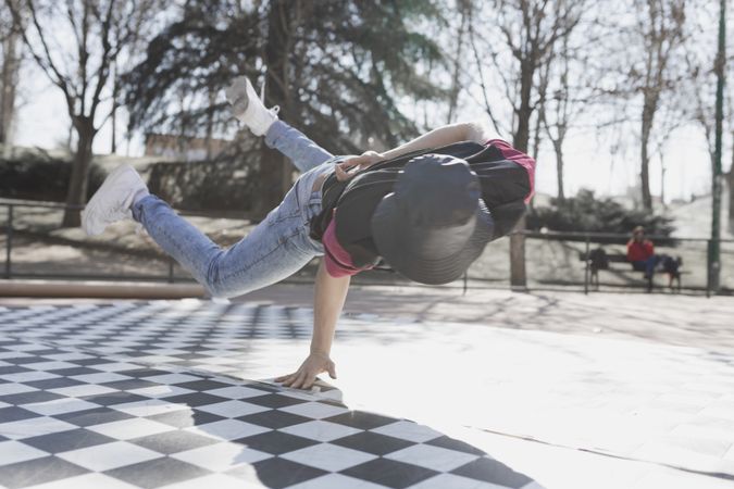 Man dancing break dance in park