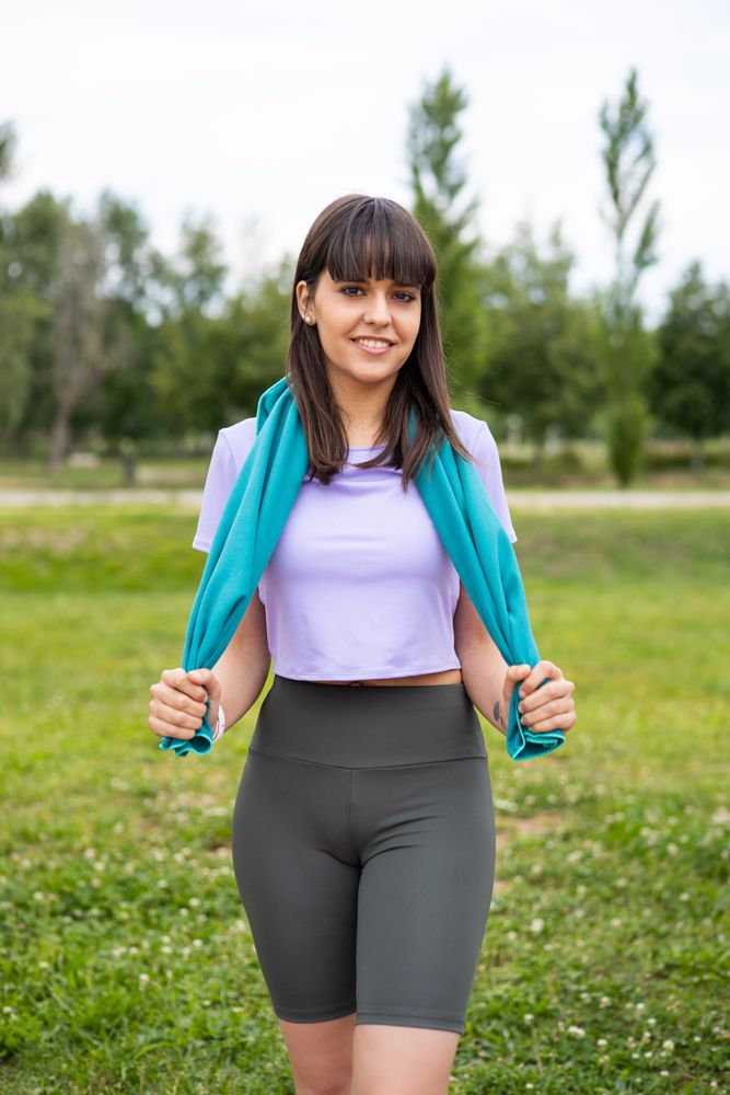 Sport woman with a towel for fitness training outdoors