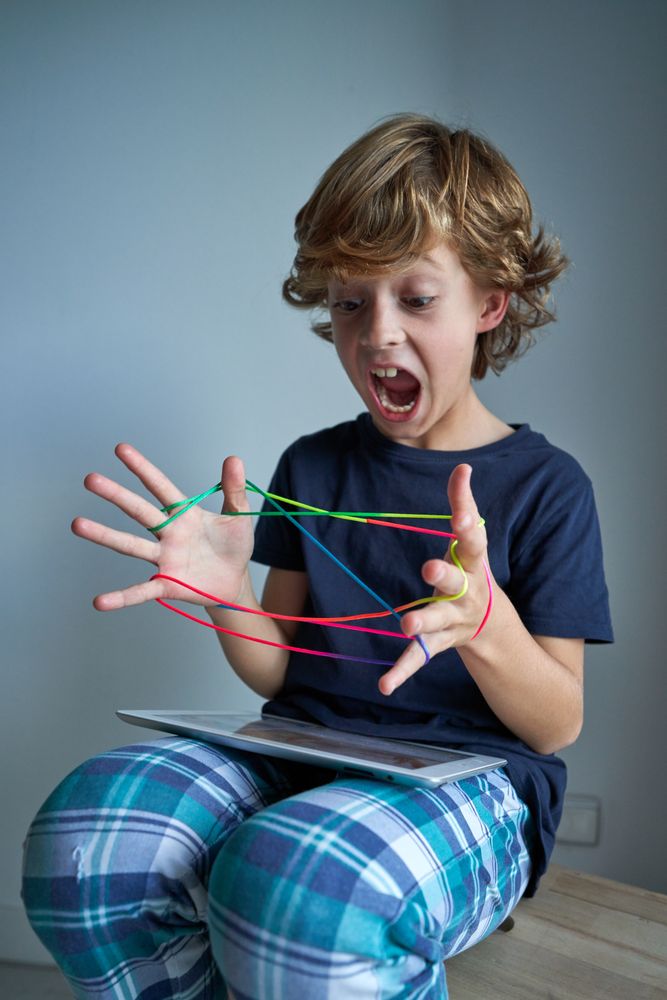 Boy screaming while playing string game