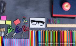 Back to school supplies placed on erased chalkboard, copy space 5naQA0