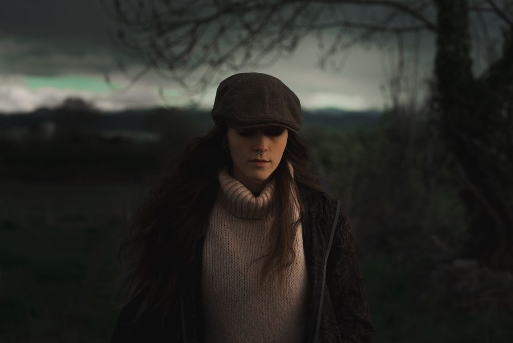 Young woman in warm clothes in forest