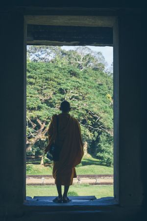Anonymous monk in entrance of old temple