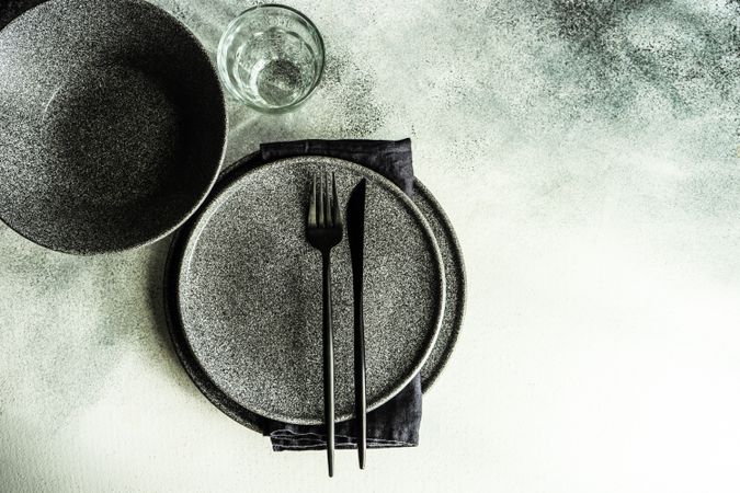 Minimalistic place setting with grey plates