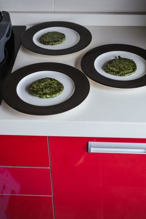 Plates with vegan cutlets in kitchen