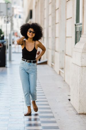 Cheerful Black female in dark sunglasses