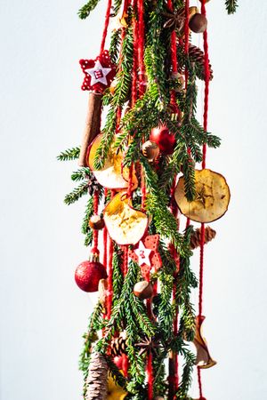 Christmas festive composition with pine, baubles and dried apple slices