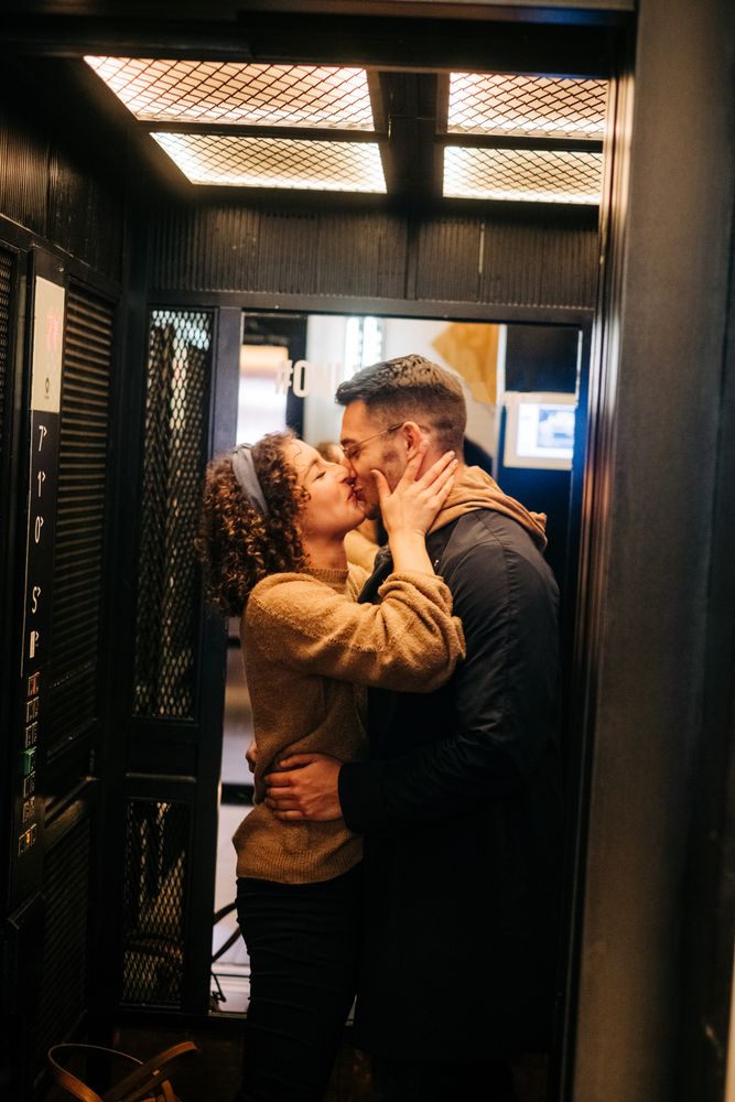 Happy couple standing in elevator