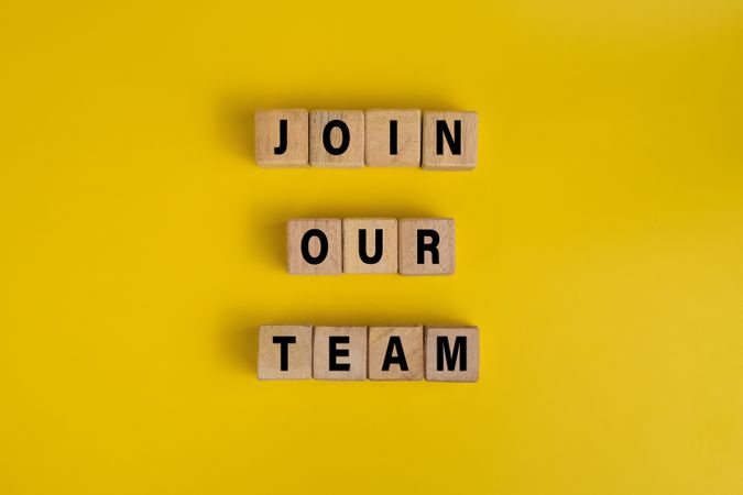 join our team words on wooden blocks isolated on yellow background. concept of business hiring employee