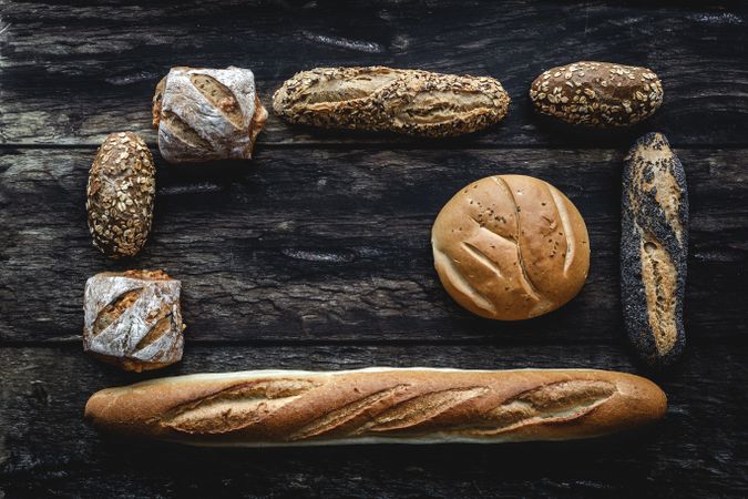 Assorted gold homemade bread on dark wood background