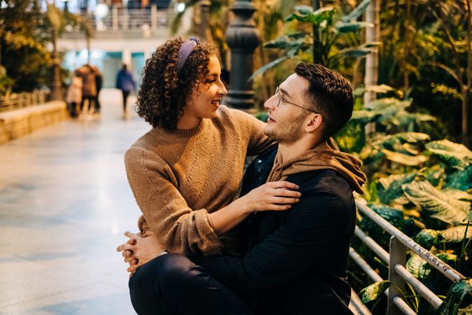 Young couple embracing on bench