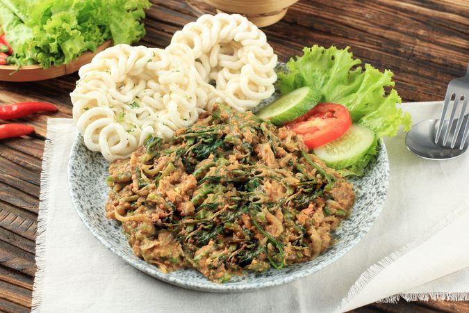 Plate of lotek, Sudanese vegetable salad with peanut dressing served with side salad