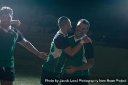 Sportsmen in uniform hugging and smiling after winning a rugby game 5lnNob