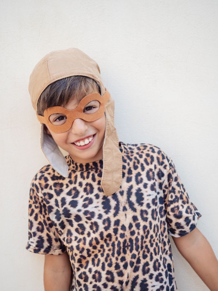 Child in leopard costume and hat with ears