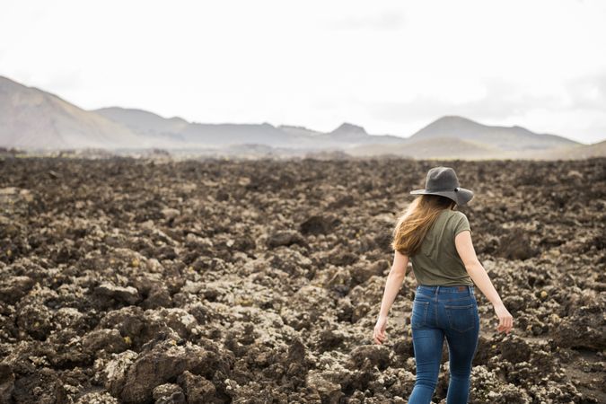 Woman walking against stony terrain