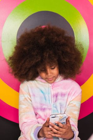 Black girl using mobile phone in studio