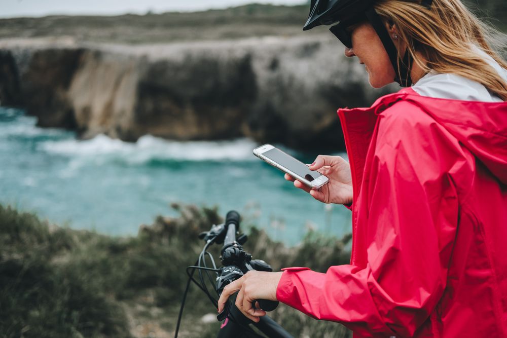 Female bicyclist using smartphone