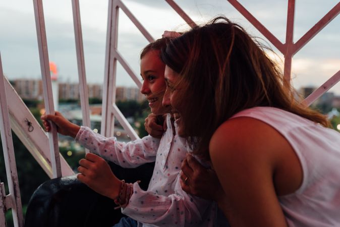 Mother and daughter riding Ferris wheel