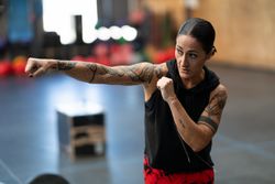 Fit woman practicing boxing in gym
