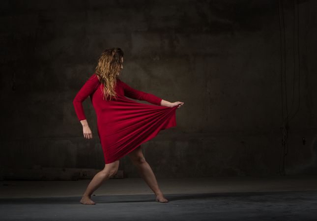 Young woman dancing in darkness