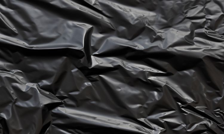 dark crumpled and creased plastic poster texture background