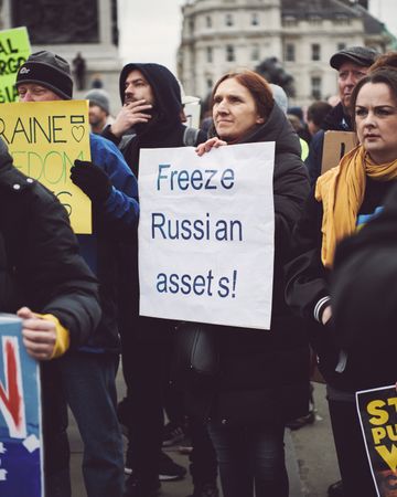 London, England, United Kingdom - March 5 2022: Woman with “Freeze Russian Assets” sign