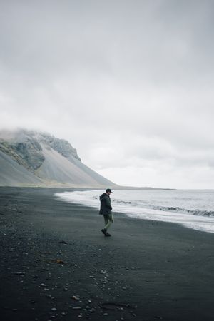 Man walking along coastline on a winter’s day