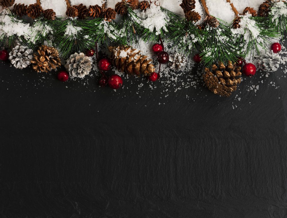 Christmas holiday top border decor on dark stone with snow