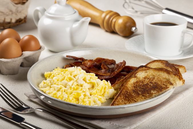 Breakfast with eggs, bacon and toast.