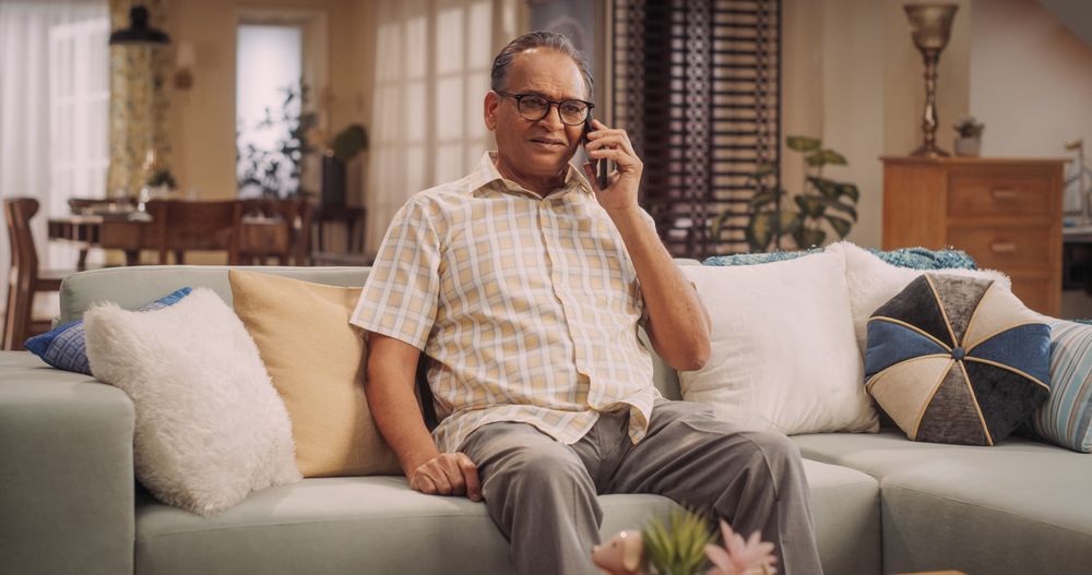 Older Indian Man Using Smartphone for Call: Cherishing Talks with Loved Ones