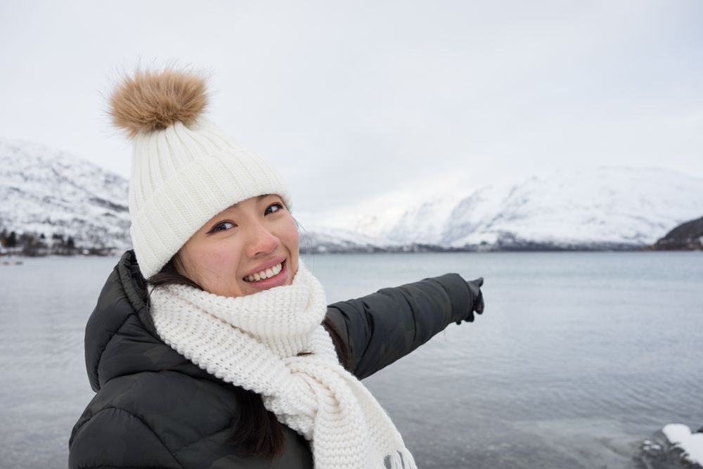 Joyful young woman in warm clothes
