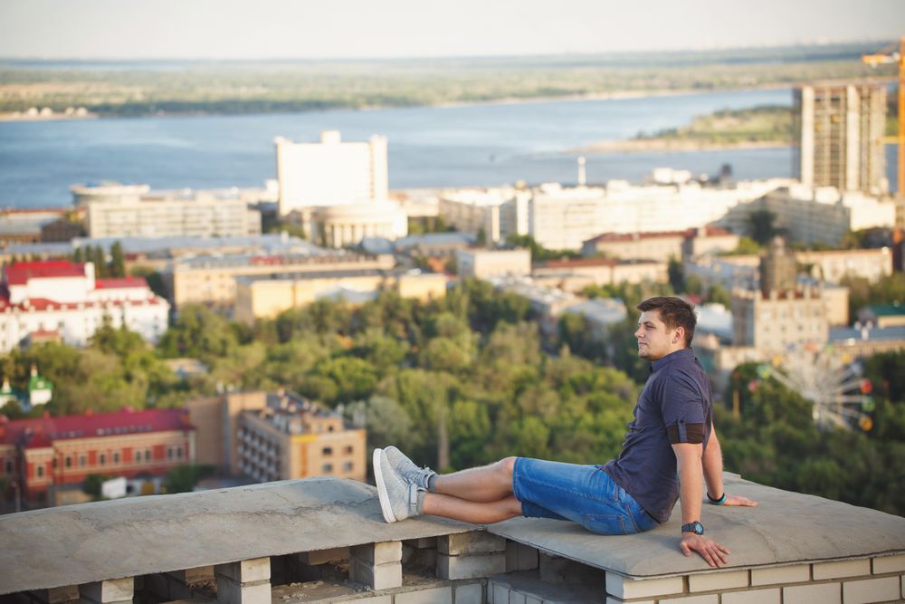 Man sitting down enjoying roof view