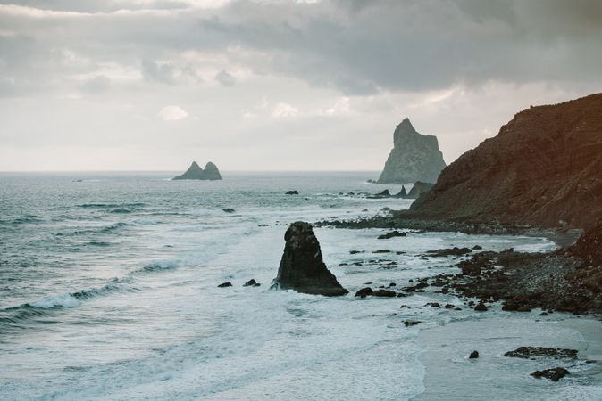Lonely cliff in sea on cloudy day