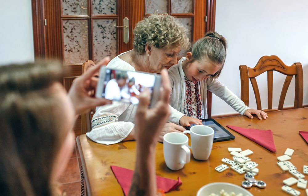 Grandmother and granddaughter play a game on the tablet