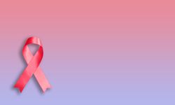 Pink ribbon on pink purple gradient background