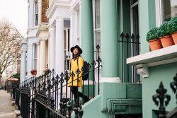 Cheerful woman standing in stairs in typical london buildings
