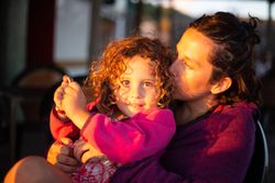 Mother and daughter enjoying sunset