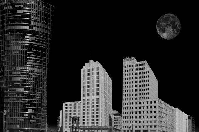 Negative photo of high-rise buildings under moon in Berlin, Germany