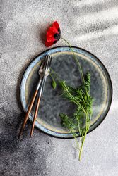 Rustic table setting of poppy on plate