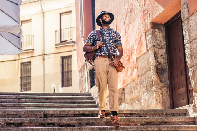 Stylish Black man walking on the city street