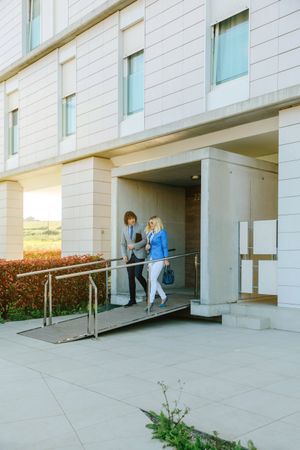 Businessman and businesswoman leaving the office