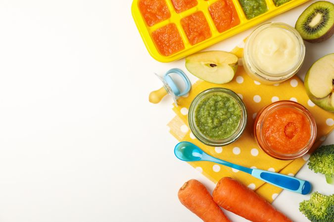 Composition with baby food on plain background, top view