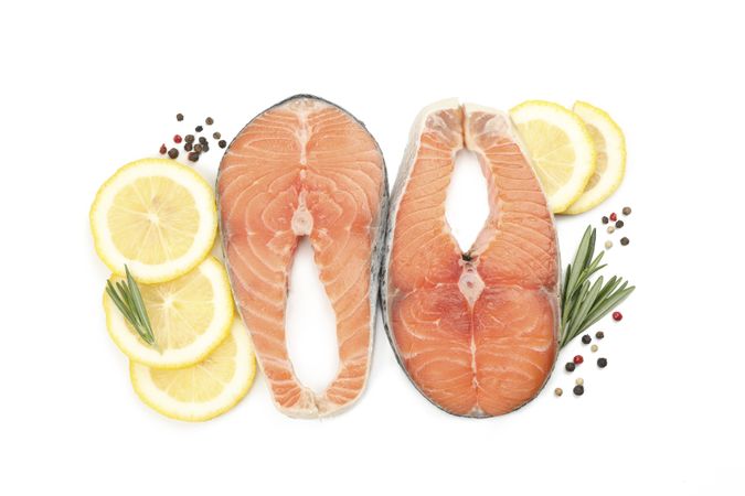 Fresh raw salmon meat and spices isolated on light background