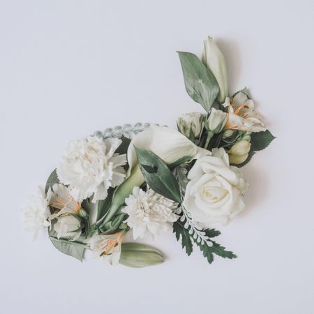 Easter layout with flowers and leaves in bunny shape on light  paper background