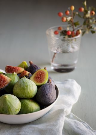 Plate of fresh ripe figs on kitchen table