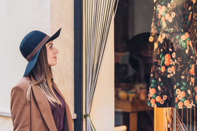 Charming woman in classy outfit shopping for dress