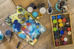 High angle view of brushes, pallete, oils, acrylics and other el