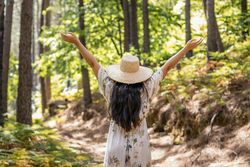 Woman enjoying a day in nature, walking through the forest