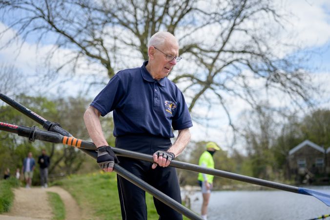 Older man preparing rowing boat