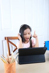 Asian Gilr Student Wearing Wireless Head Phone Learning with Tablet