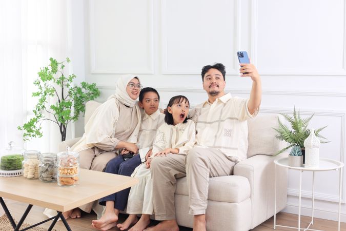 Asian Muslim Family Taking Selfie Photo during Eid Al Fitr Celebration
